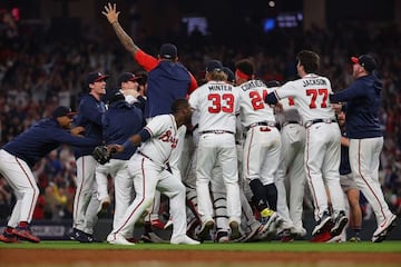 ATLANTA, GEORGIA - OCTOBER 23: Members of the Atlanta Braves celebrate after defeating the Los Angeles Dodgers in Game Six of the National League Championship Series at Truist Park on October 23, 2021 in Atlanta, Georgia. The Braves defeated the Dodgers 4